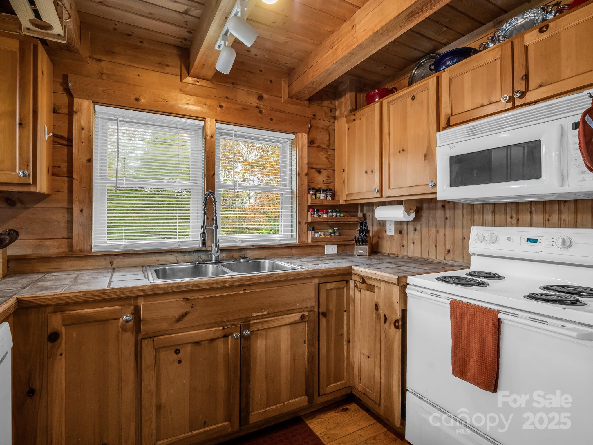 557 Emerald Parkway Rutherfordton, NC 28139 - Photo 17 of 48 a kitchen with stainless steel appliances a sink stove and window