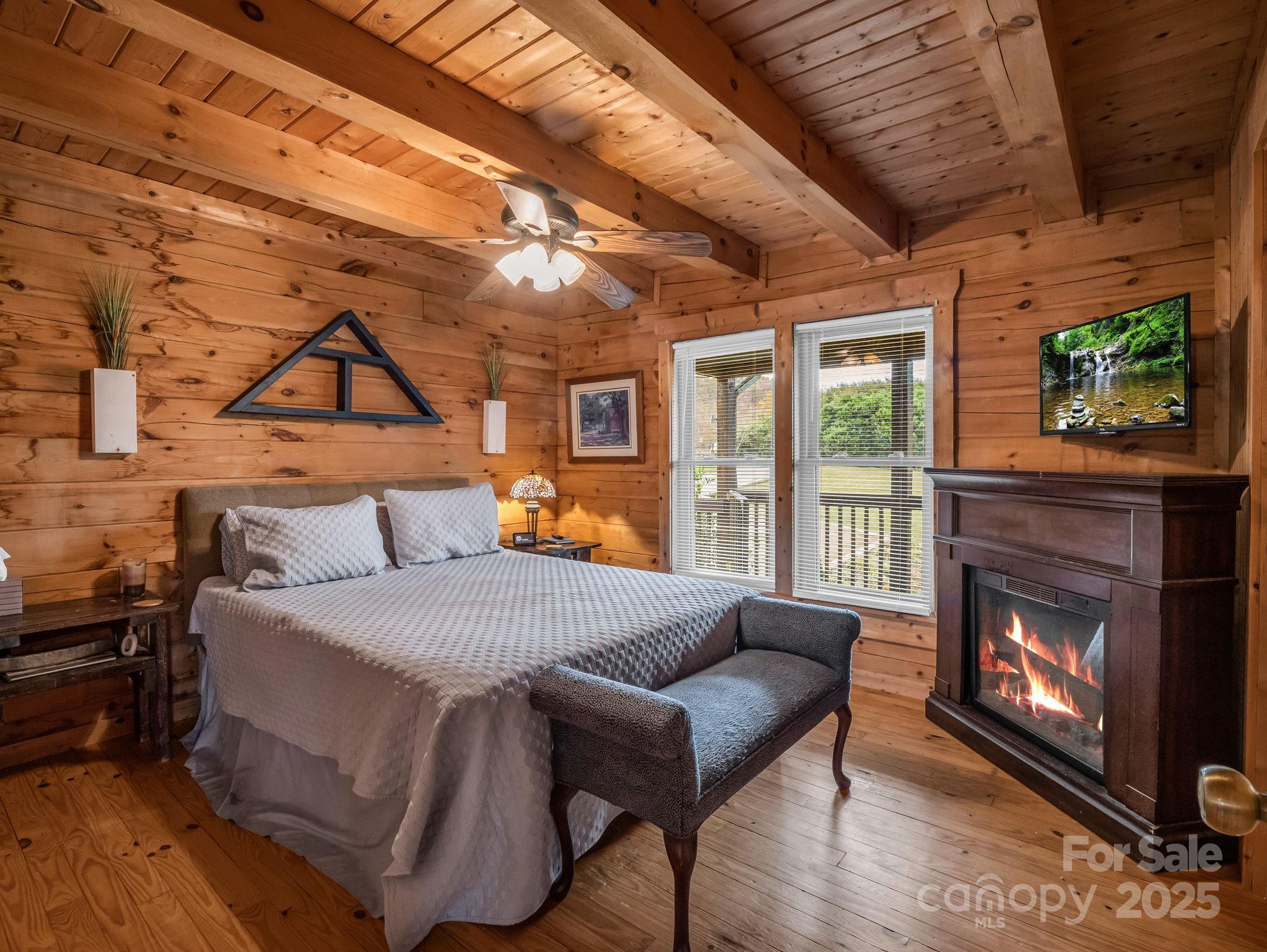 557 Emerald Parkway Rutherfordton, NC 28139 - Photo 19 of 48 a bed room with a bed and a fireplace