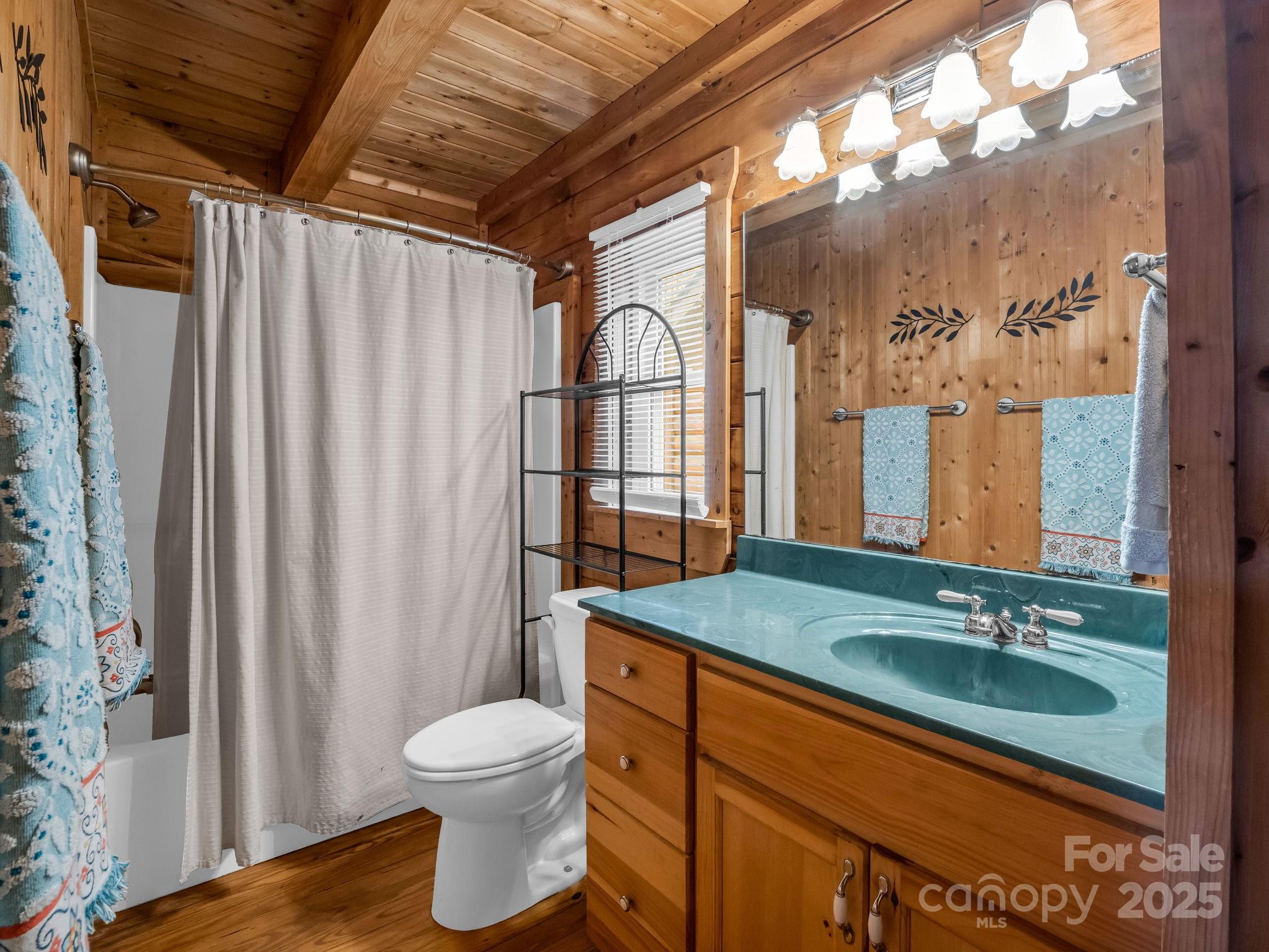 557 Emerald Parkway Rutherfordton, NC 28139 - Photo 21 of 48 a bathroom with a granite countertop sink toilet a mirror and shower