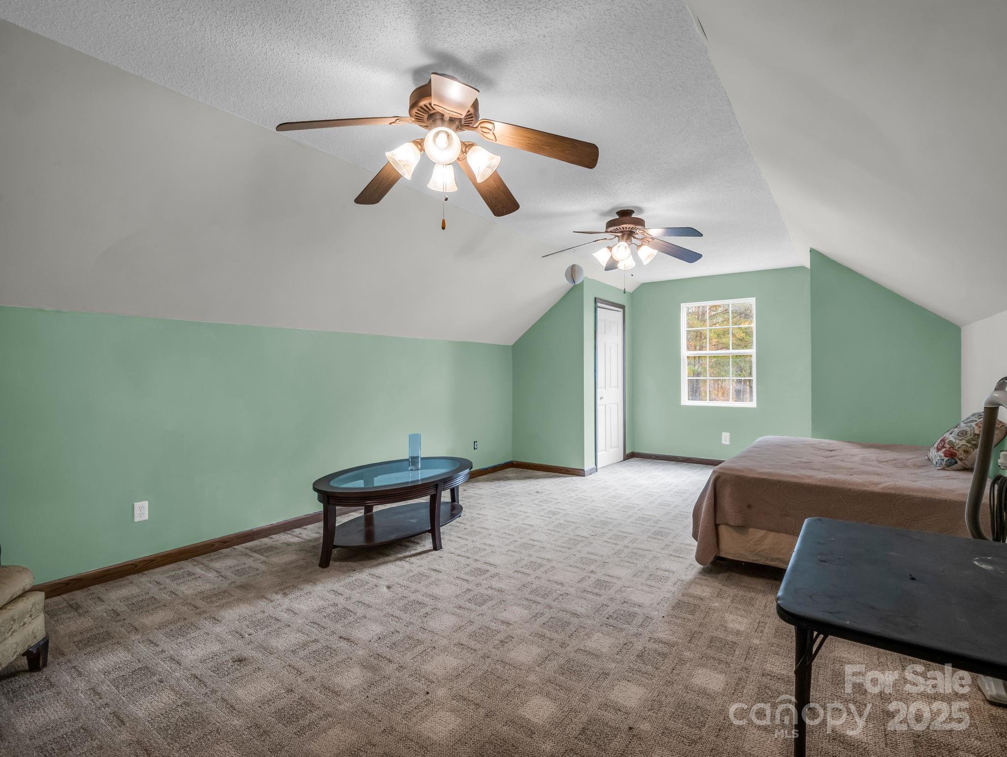 557 Emerald Parkway Rutherfordton, NC 28139 - Photo 46 of 48 a bedroom with a bed and a chandelier