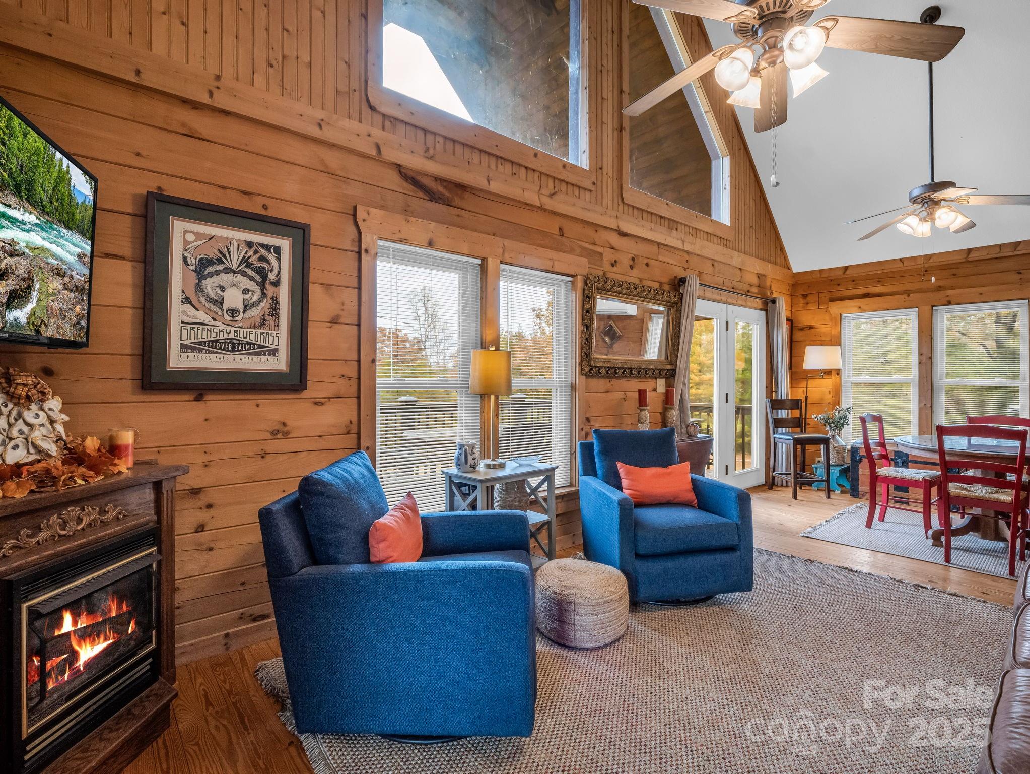 557 Emerald Parkway Rutherfordton, NC 28139 - Photo 10 of 48 a living room with furniture a fireplace and large windows