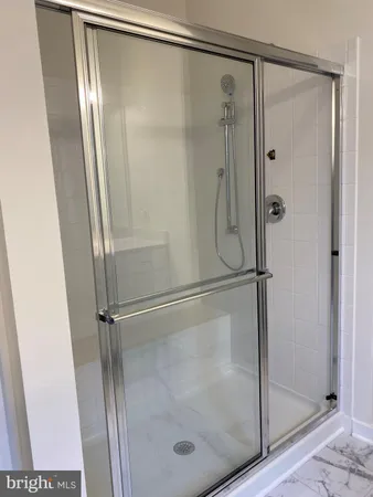 a bathroom with a glass shower door
