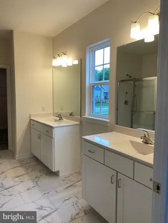 a bathroom with a sink double vanity and a mirror