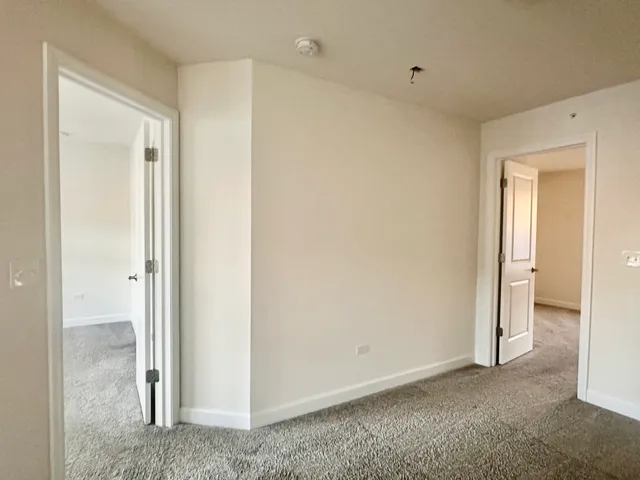 a spacious bathroom with a granite countertop sink a mirror and shower