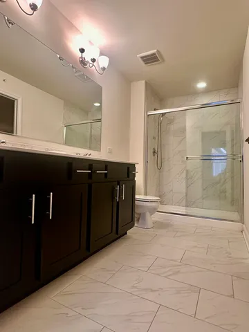 a bathroom with a sink a toilet and a mirror