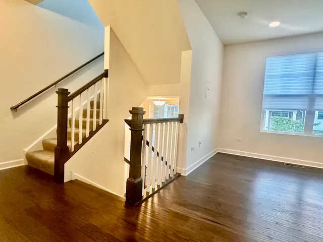 a view of an entryway with wooden floor and door