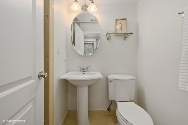3535 North Reta Avenue, Unit 2 Chicago, IL 60657 - Photo 11 of 12 a bathroom with a sink a toilet and mirror