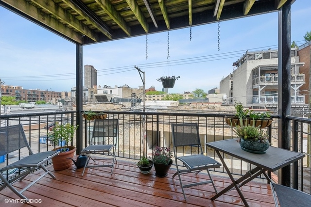 3535 North Reta Avenue, Unit 2 Chicago, IL 60657 - Photo 12 of 12 a view of a balcony with chairs and wooden floor