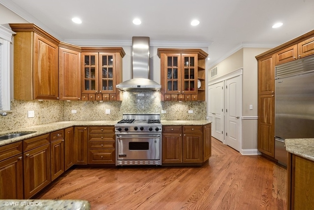 3535 North Reta Avenue, Unit 2 Chicago, IL 60657 - Photo 6 of 12 a kitchen with stainless steel appliances granite countertop a stove a sink and a refrigerator