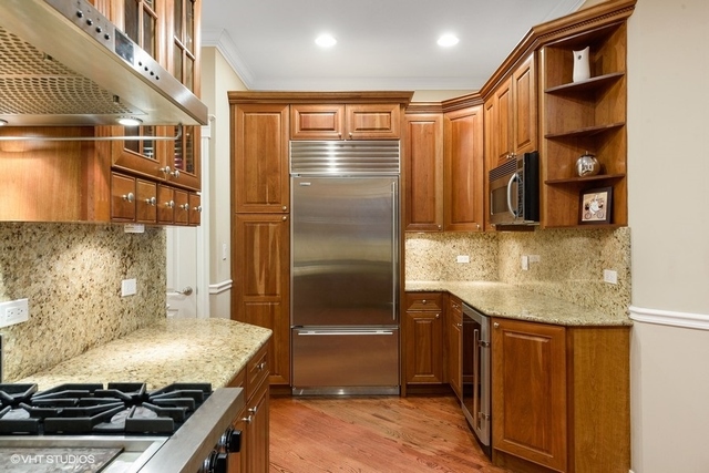 3535 North Reta Avenue, Unit 2 Chicago, IL 60657 - Photo 7 of 12 a kitchen with granite countertop a sink and a refrigerator