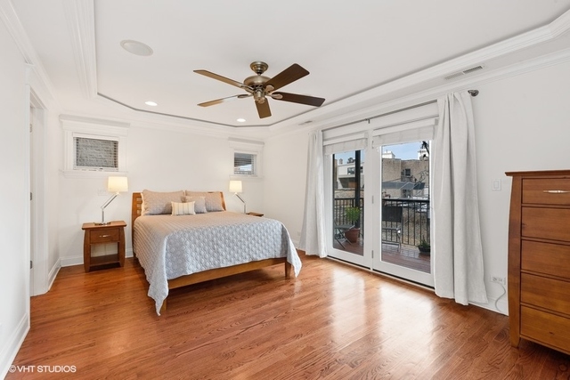 3535 North Reta Avenue, Unit 2 Chicago, IL 60657 - Photo 8 of 12 a bedroom with a large bed and wooden floor