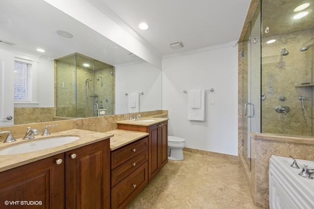 3535 North Reta Avenue, Unit 2 Chicago, IL 60657 - Photo 9 of 12 a spacious bathroom with a shower sink vanity and mirror