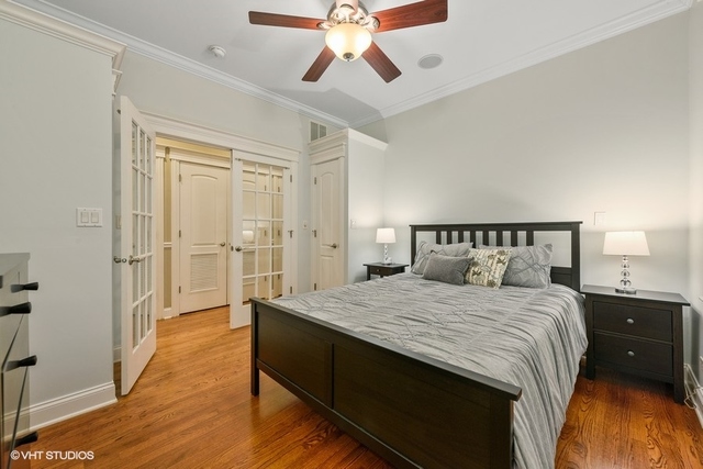 3535 North Reta Avenue, Unit 2 Chicago, IL 60657 - Photo 10 of 12 a bedroom with a bed and a chandelier