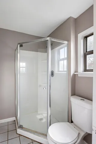 a bathroom with a toilet and a shower