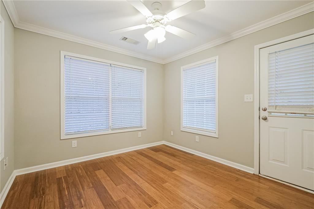 75 Pebble Crossing Covington, GA 30016 - Photo 11 of 27 a view of an empty room with a window and wooden floor
