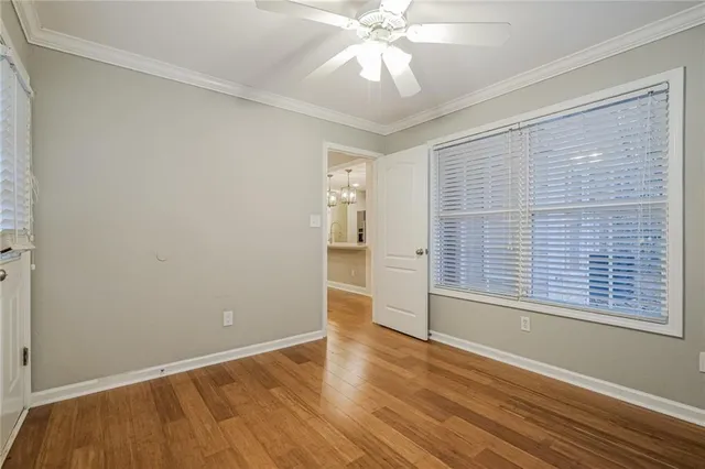 an empty room with a ceiling fan and a fan