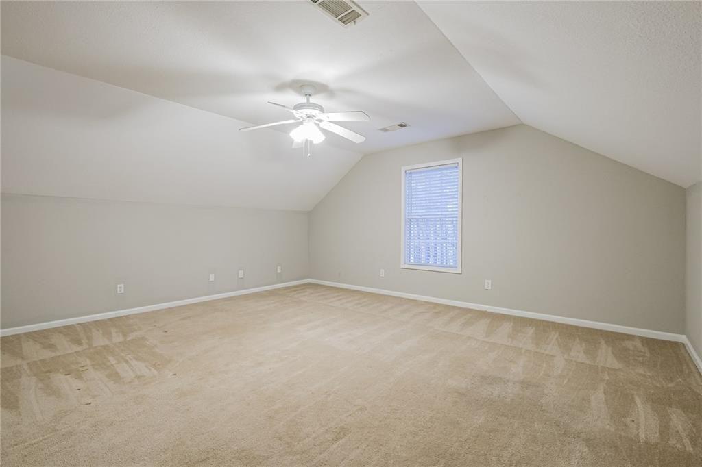 75 Pebble Crossing Covington, GA 30016 - Photo 13 of 27 an empty room with a window and ceiling fan