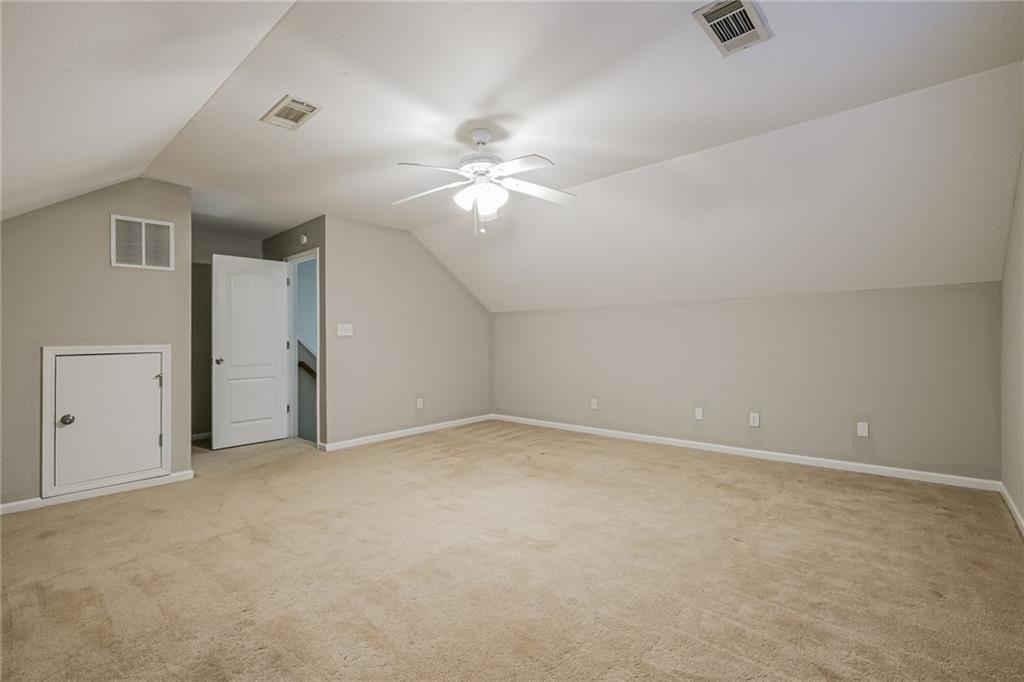 75 Pebble Crossing Covington, GA 30016 - Photo 14 of 27 an empty room with a ceiling fan and a fan