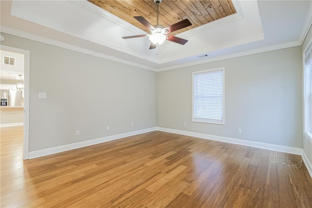 75 Pebble Crossing Covington, GA 30016 - Photo 16 of 27 an empty room with wooden floor and ceiling fan