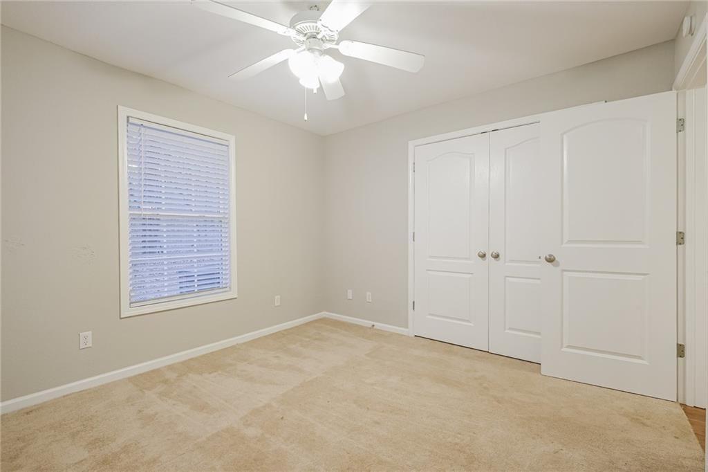 75 Pebble Crossing Covington, GA 30016 - Photo 19 of 27 an empty room with windows and fan