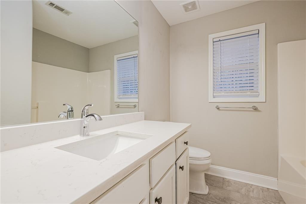 75 Pebble Crossing Covington, GA 30016 - Photo 22 of 27 a bathroom with a sink toilet and mirror