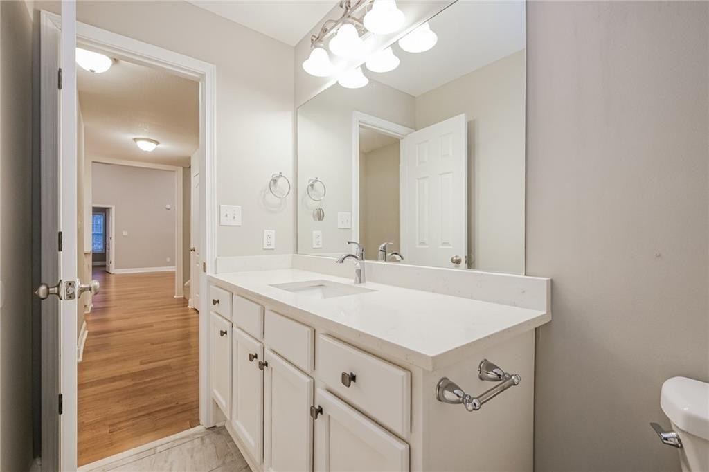 75 Pebble Crossing Covington, GA 30016 - Photo 23 of 27 a bathroom with a sink vanity and a mirror