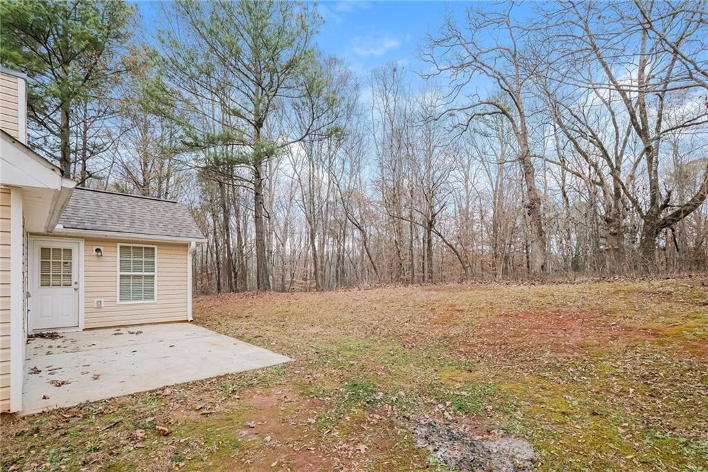 75 Pebble Crossing Covington, GA 30016 - Photo 24 of 27 a view of a yard with trees in front of it