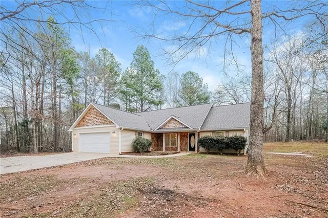 a view of a livingroom with a ceiling fan window and wooden floor