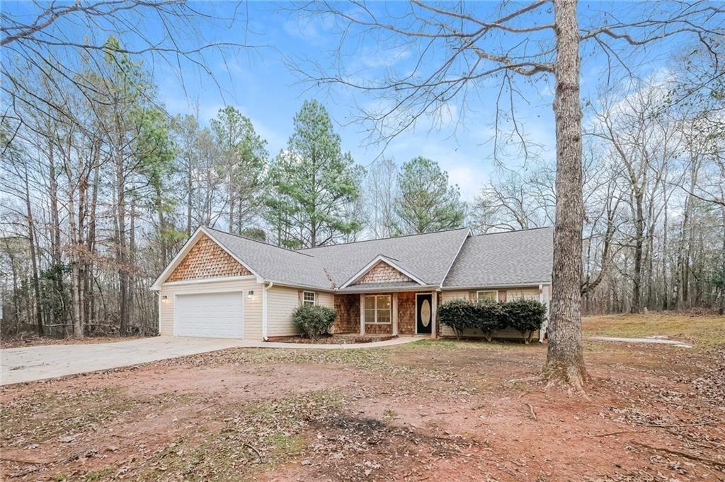 75 Pebble Crossing Covington, GA 30016 - Photo 4 of 27 a view of house with backyard and trees