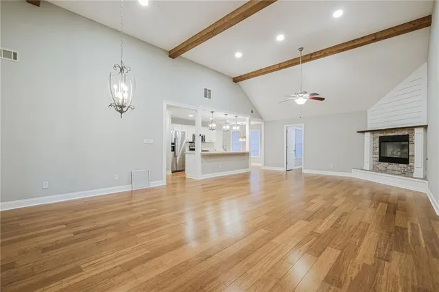 a kitchen with a sink a stove a refrigerator and white cabinets