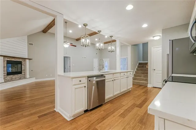 a spacious bathroom with a granite countertop sink mirror and a large window