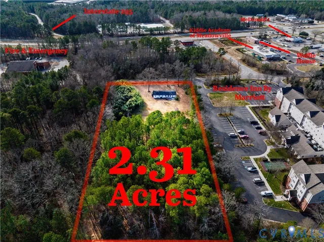 an aerial view of a house with a swimming pool