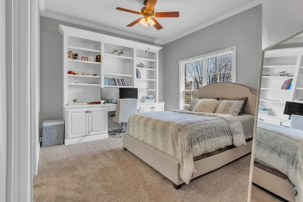 a spacious bedroom with a bed and a window