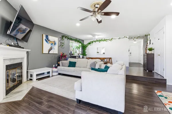 a living room with furniture and a fireplace