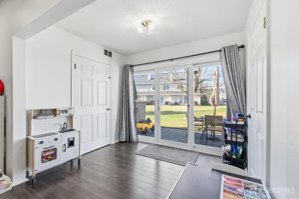 an empty room with toys and wooden floor