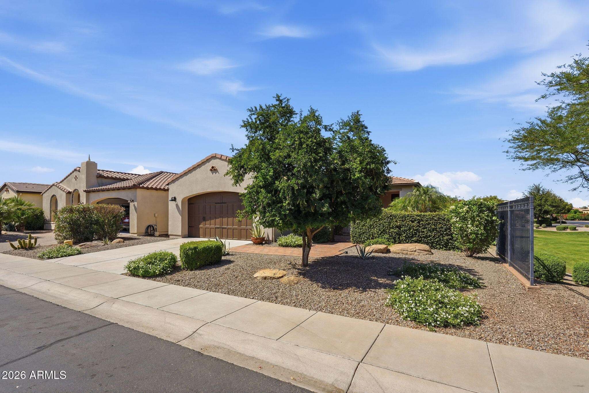 1694 East Grand Ridge Road Queen Creek, AZ 85140 - Photo 46 of 61 a front view of a house with a yard and garage