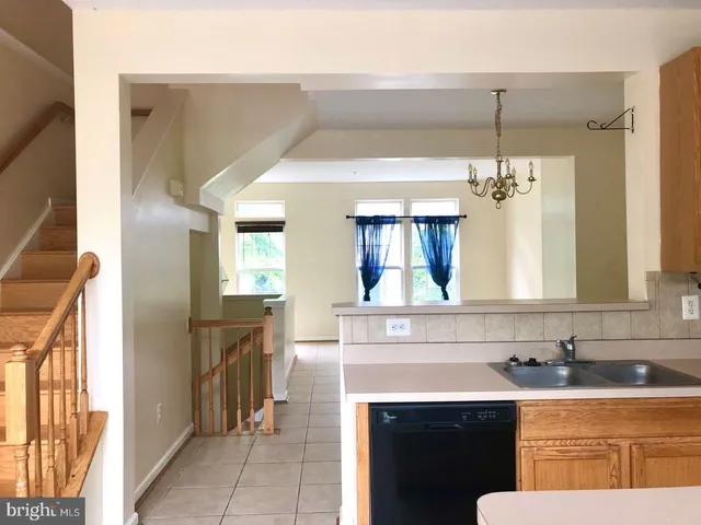 a kitchen with a sink dishwasher a stove and a refrigerator with wooden floor