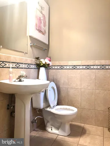 a bathroom with a toilet a sink and mirror