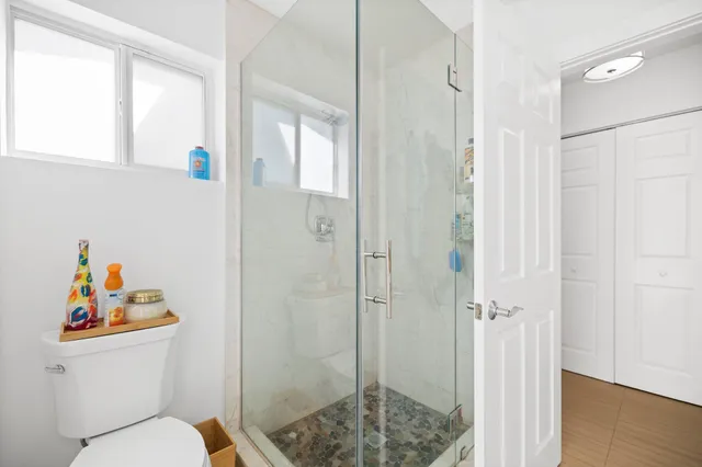 a bathroom with a toilet a sink and shower