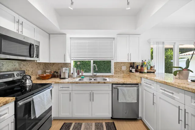 a kitchen with a sink stove and microwave