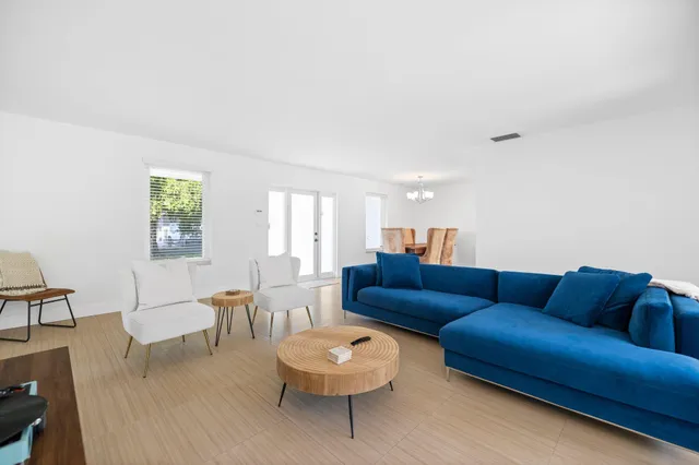 a living room with furniture a rug and a window