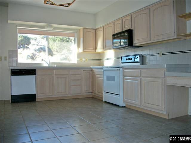 35 Rogers Ranch Road Sparks, NV 89441 - Photo 3 of 13 a kitchen with cabinets appliances and a window
