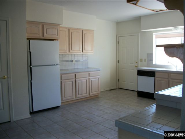 35 Rogers Ranch Road Sparks, NV 89441 - Photo 4 of 13 a white refrigerator freezer sitting inside of a kitchen