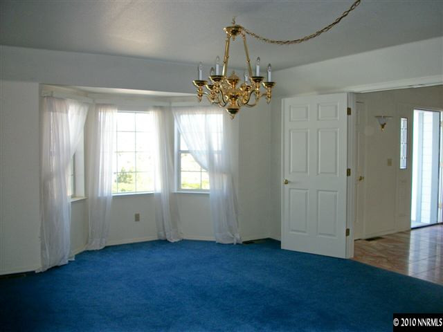35 Rogers Ranch Road Sparks, NV 89441 - Photo 5 of 13 an empty room with windows and chandelier