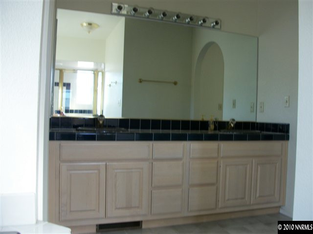 35 Rogers Ranch Road Sparks, NV 89441 - Photo 7 of 13 a bathroom with a sink and a mirror