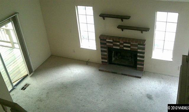 4309 Pescado Way Reno, NV 89502 - Photo 7 of 9 an empty room with windows and fireplace