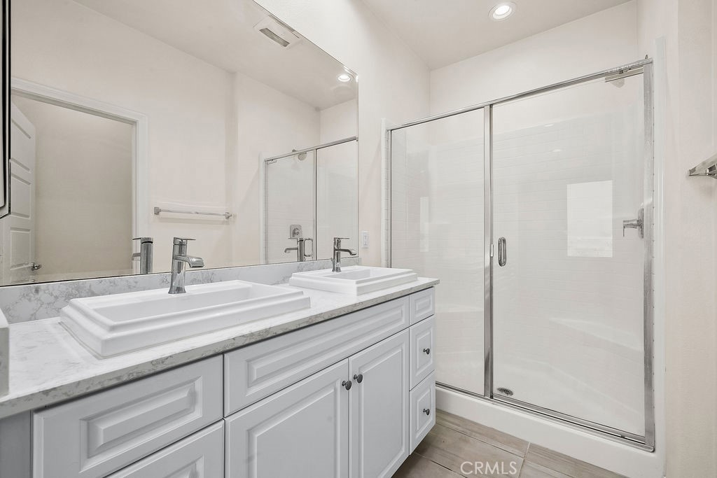 159 Steely Irvine, CA 92614 - Photo 14 of 30 Primary bathroom with dual vanity and glass-enclosed shower.