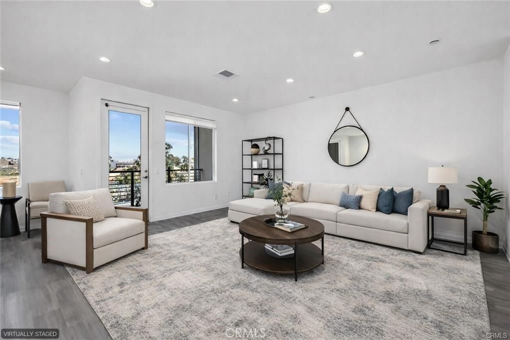 159 Steely Irvine, CA 92614 - Photo 2 of 30 Bright, open-concept living room with abundant natural light and direct access to private balcony (virtually staged).