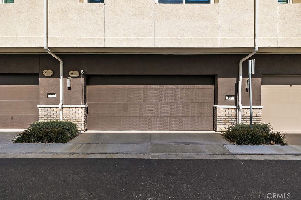 159 Steely Irvine, CA 92614 - Photo 22 of 30 Exterior garage access with modern townhome design.