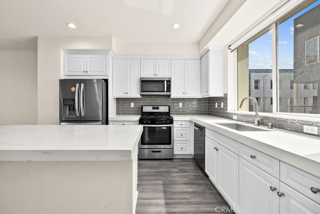 159 Steely Irvine, CA 92614 - Photo 6 of 30 Kitchen with expansive counter space, stainless steel appliances, and window for natural light.